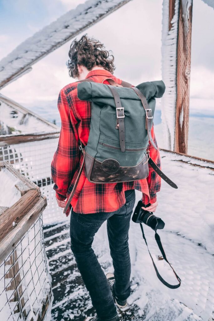 man with camera wearing a Duluth Pack bag