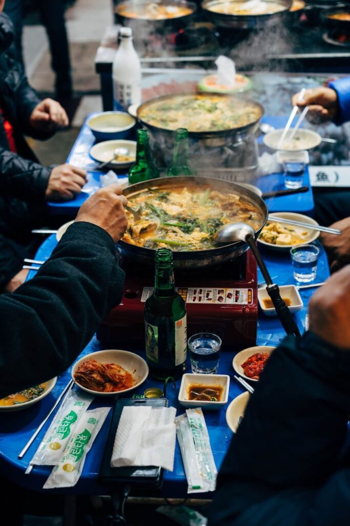 men sharing drinks and jjigae