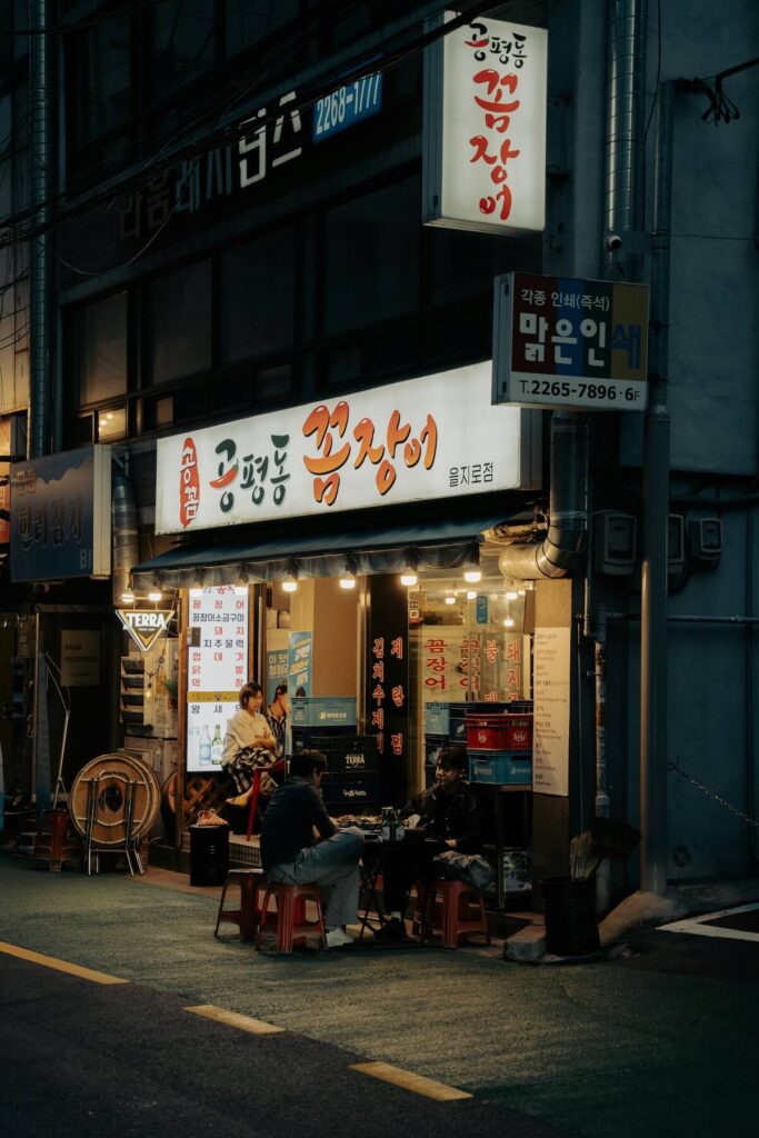 two men drinking outside Korean restaurant