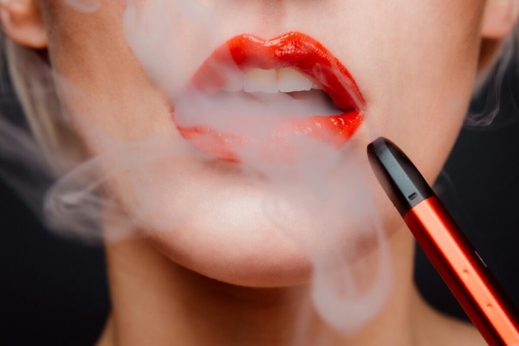 woman with red lipstick vaping